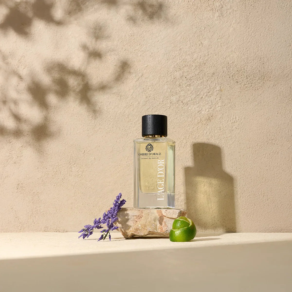 Ombre d’Orage by L’Âge d’Or luxury perfume bottle styled with lavender, lime and stone on natural beige background