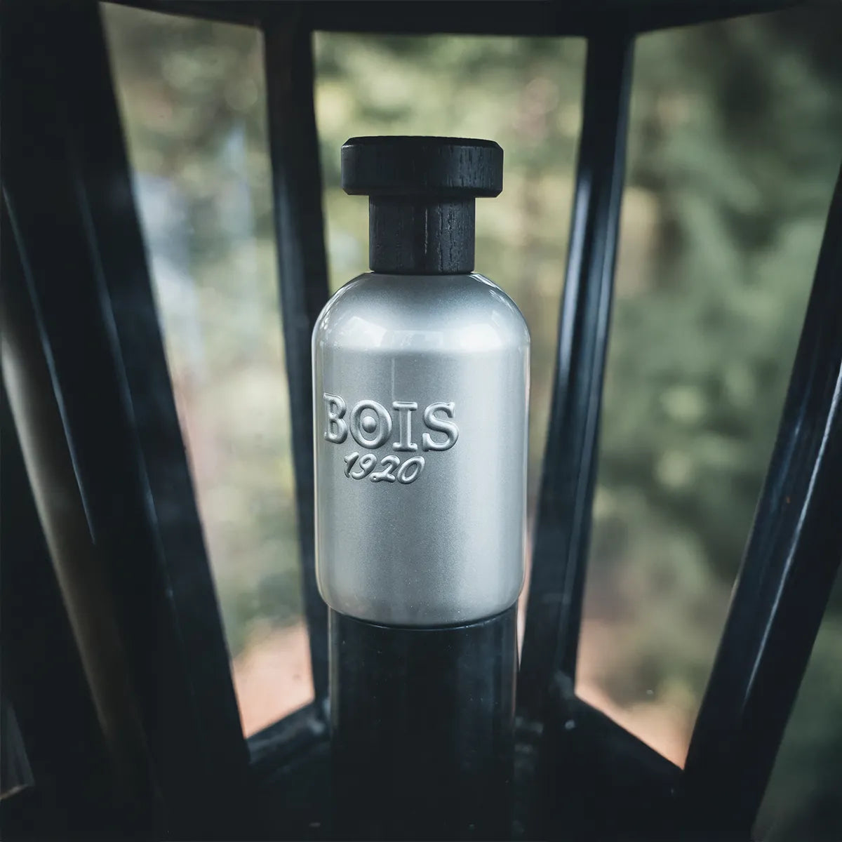 BOIS 1920 perfume bottle on a blurred natural background
