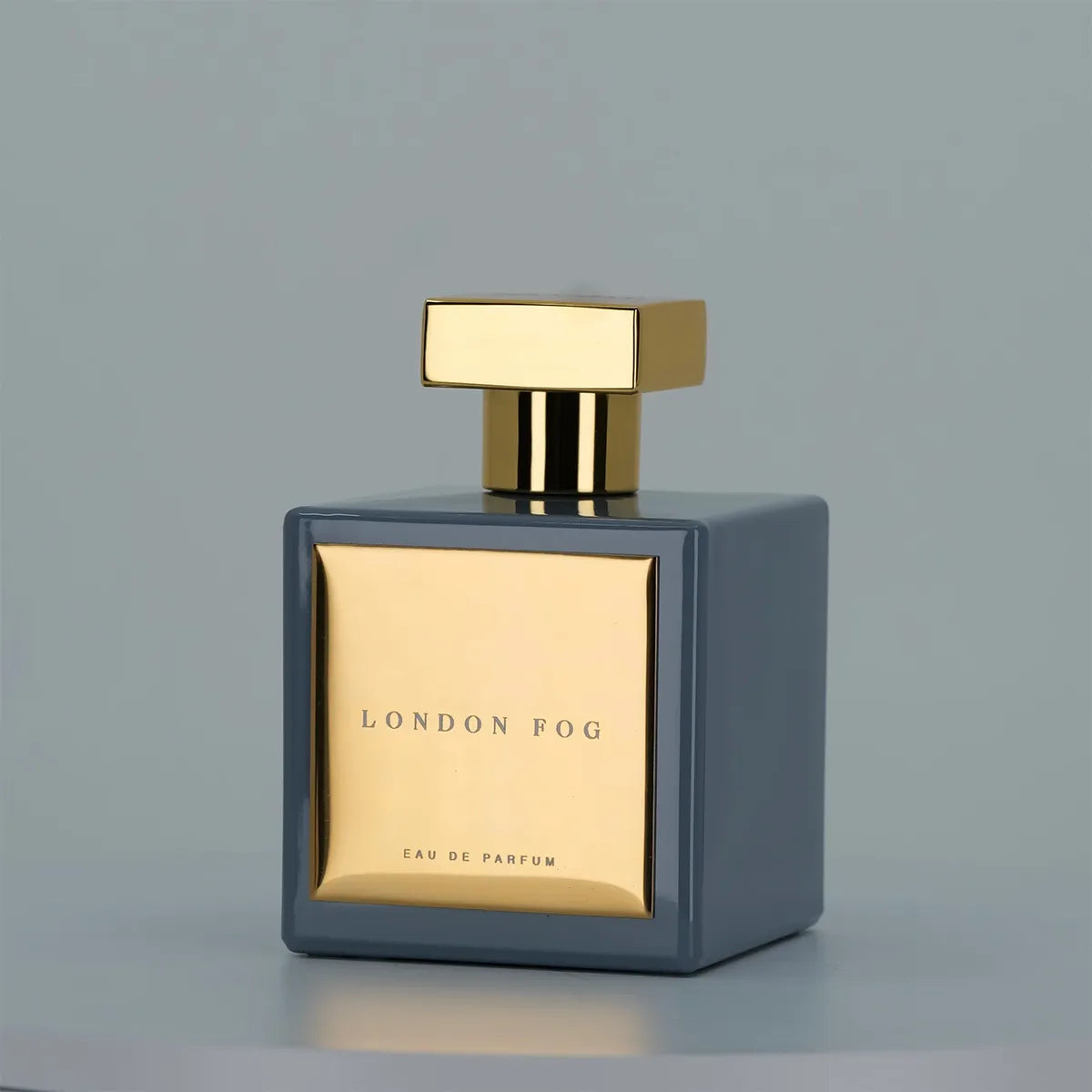 Perfume bottle with gold cap and label on a gray background