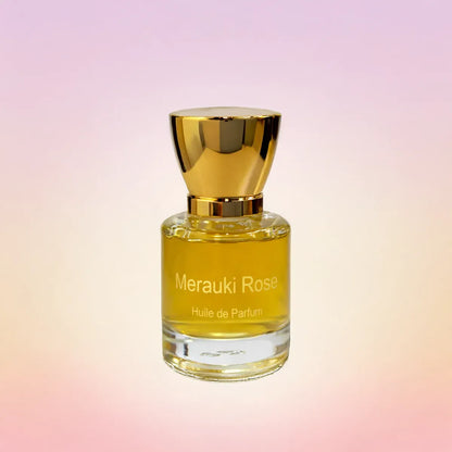 Merauki Rose huile de parfum bottle with warm golden tones on a soft pink gradient backdrop