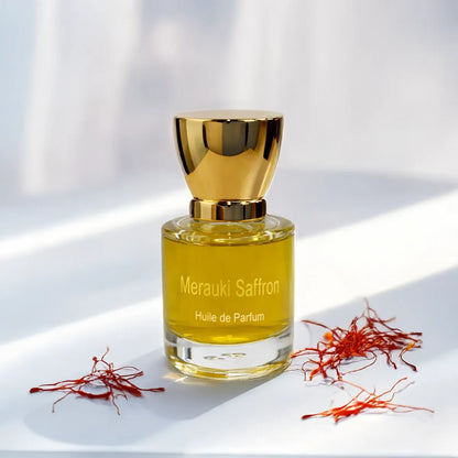 Merauki Saffron huile de parfum surrounded by vibrant saffron strands in soft natural light
