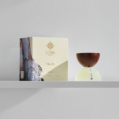Mochi by LOVA perfume bottle with elegant packaging box on neutral grey background
