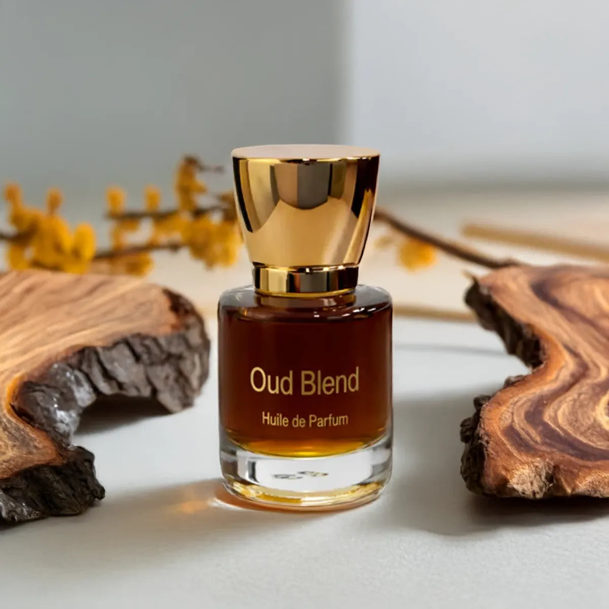 Oud Blend fragrance bottle surrounded by textured wood and warm earthy tones